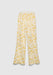 A pair of cream-colored wide-leg pants with a relaxed fit, featuring a soft waistband and a delicate yellow floral print, displayed against a plain background.