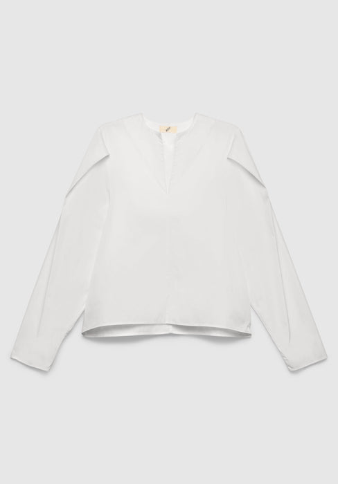 A white long-sleeve blouse with a relaxed fit, featuring a notch neckline and clean, minimal design, displayed against a plain background.
