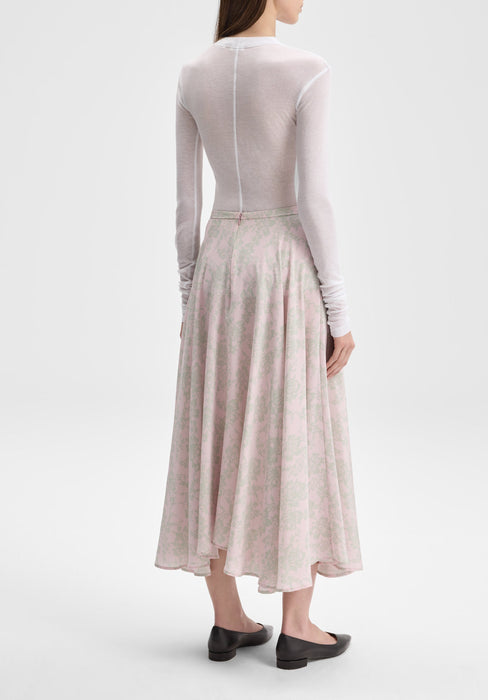 The outfit is shown from a rear three-quarter angle, with the model turned slightly to the side so both the back and a hint of the profile are visible.