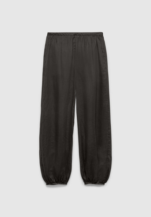 A pair of dark gray relaxed-fit pants with an elastic waistband and gathered cuffs at the ankles, featuring a lightweight, slightly textured fabric, displayed against a plain background.