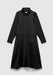 A black long-sleeve midi dress with a relaxed A-line silhouette, featuring a high draped collar, concealed front closure, and large flap pockets, displayed against a plain background.