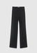 A pair of black wide‑leg dress pants laid flat on a light gray background, featuring a tailored crease down each leg, belt loops, and side pockets.