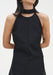 Close-up of a sleeveless black dress with a high choker-style neckline and clean, structured bodice.
